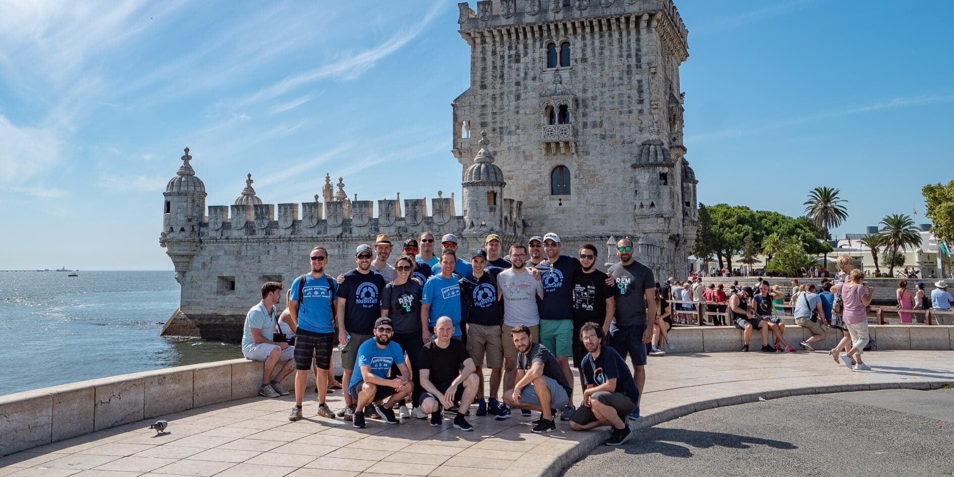 hubstaff team on annual retreat in front of tower belem
