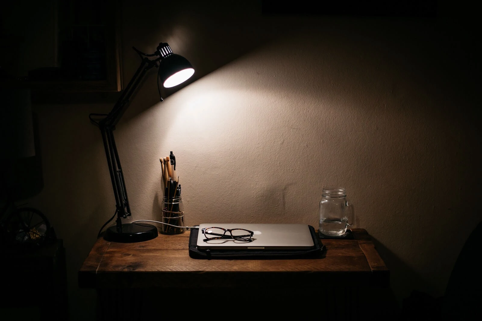 Desk with light on while working late