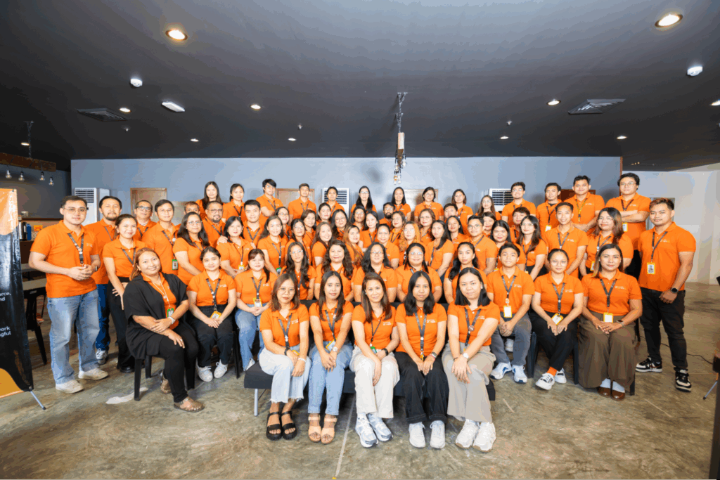 Group photo of the Affordable Staff team, featuring employees wearing matching orange shirts.