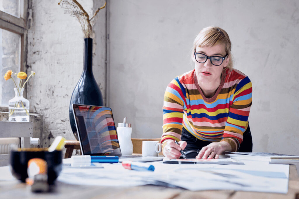 Image showing a woman freelancer drawing on paper.